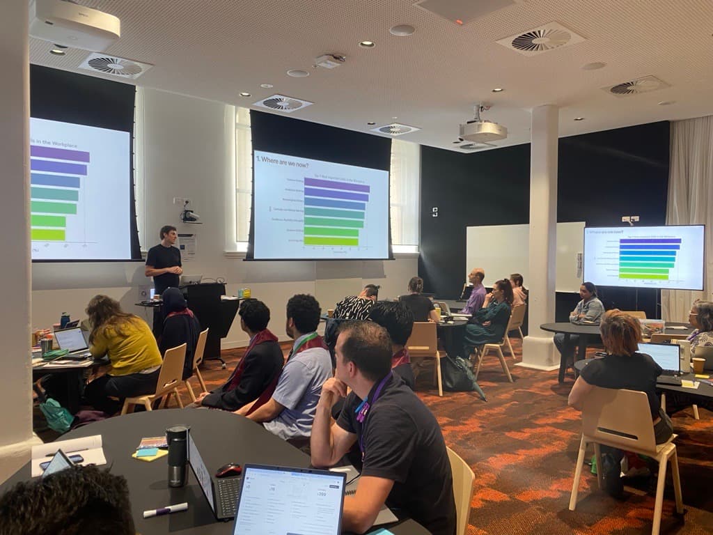 Chris Bush speaking with a microphone at a conference